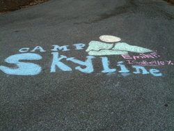 Camp Skyline's logo drawn in chalk by Birmingham campers.