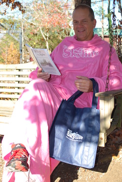 Pickle modeling Skyline's snuggie, cookbook, and grocery bag