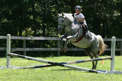 Equestrian Program camper practicing her jumping skills