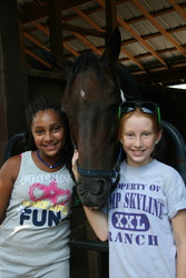 Equestrian campers caring for the horses